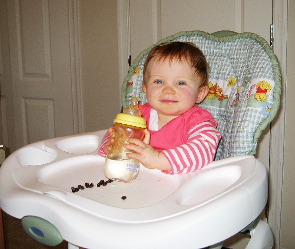 Big girl holds her own bottle